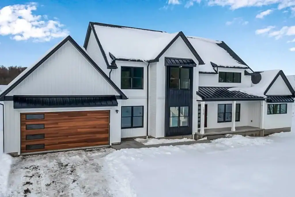 Sectional garage door installed on a residential building in winter conditions