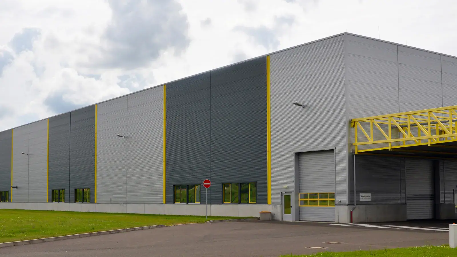 Exterior of the HONMEN Group manufacturing facility with loading bays in Taizhou, China