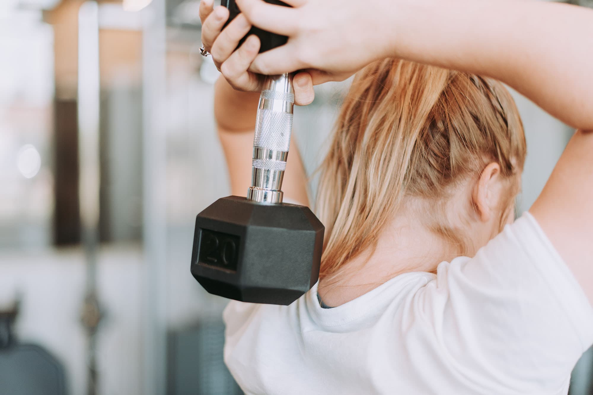 Photo of woman lifting weight in gym in San Pedro Today magazine
