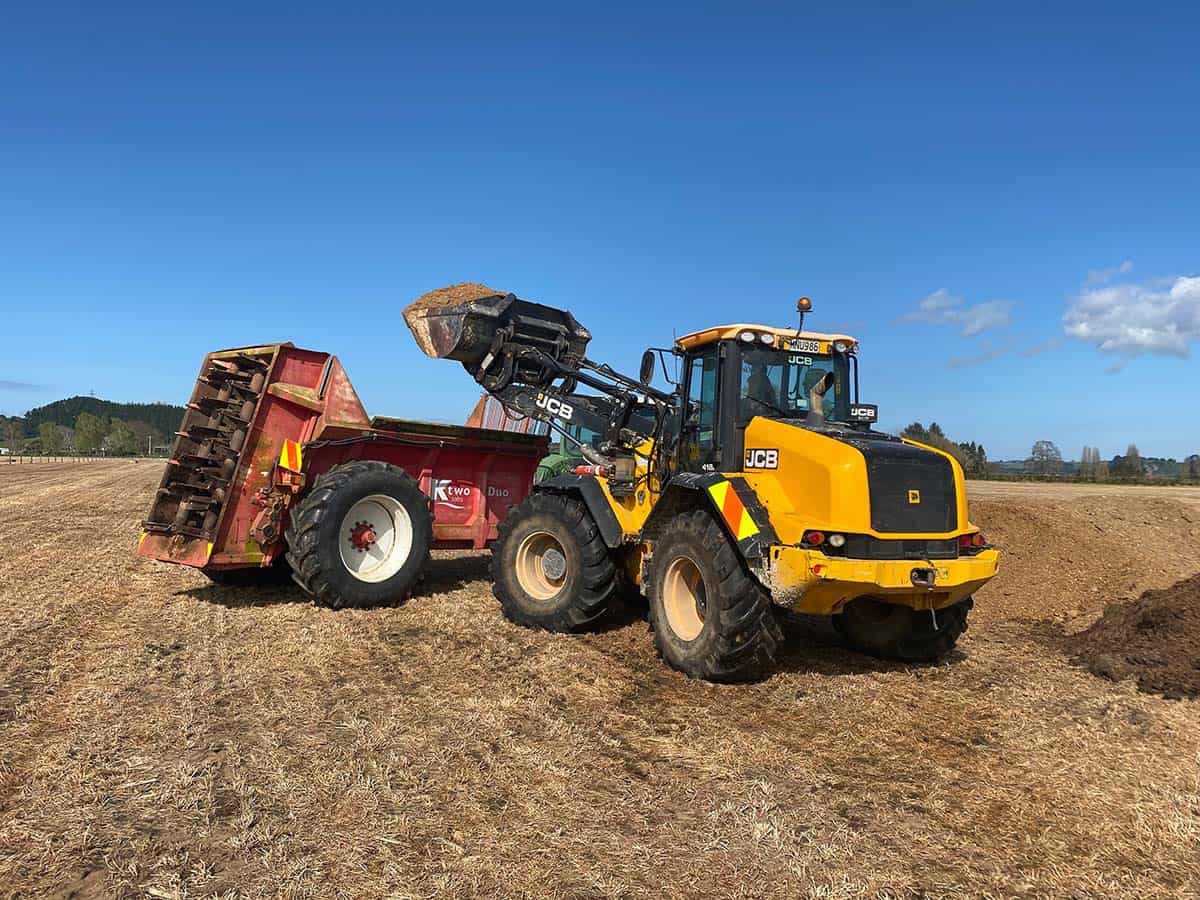 Groundwork machinery working on farmland with clear blue sky in the background.