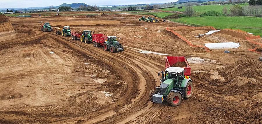 Tractors working on large-scale construction or farming project in rural New Zealand.
