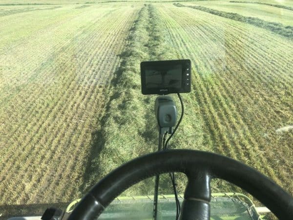 Precision agriculture machinery operating in a crop field in New Zealand.