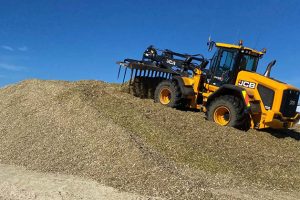 Sanson Agriculture equipment loading gravel on a farm site in New Zealand.