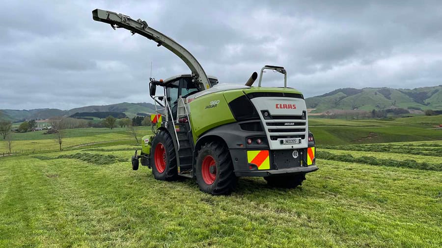 New Zealand agricultural machinery on lush farmland.