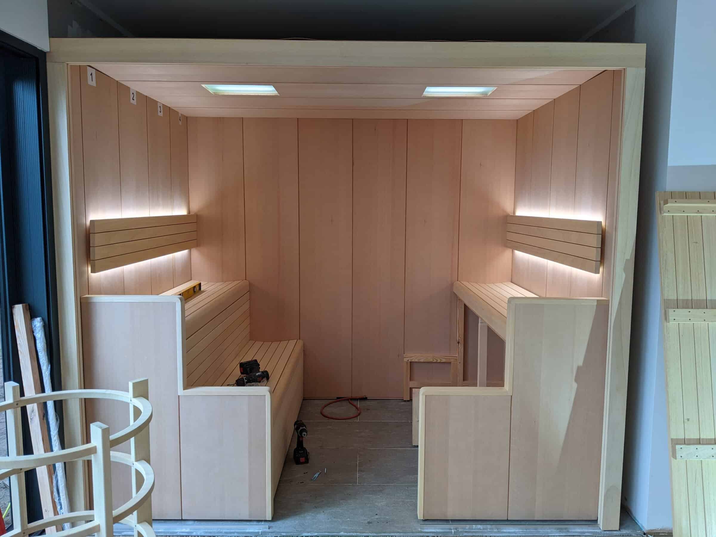 wooden sauna cabin with built-in benches and soft lighting.