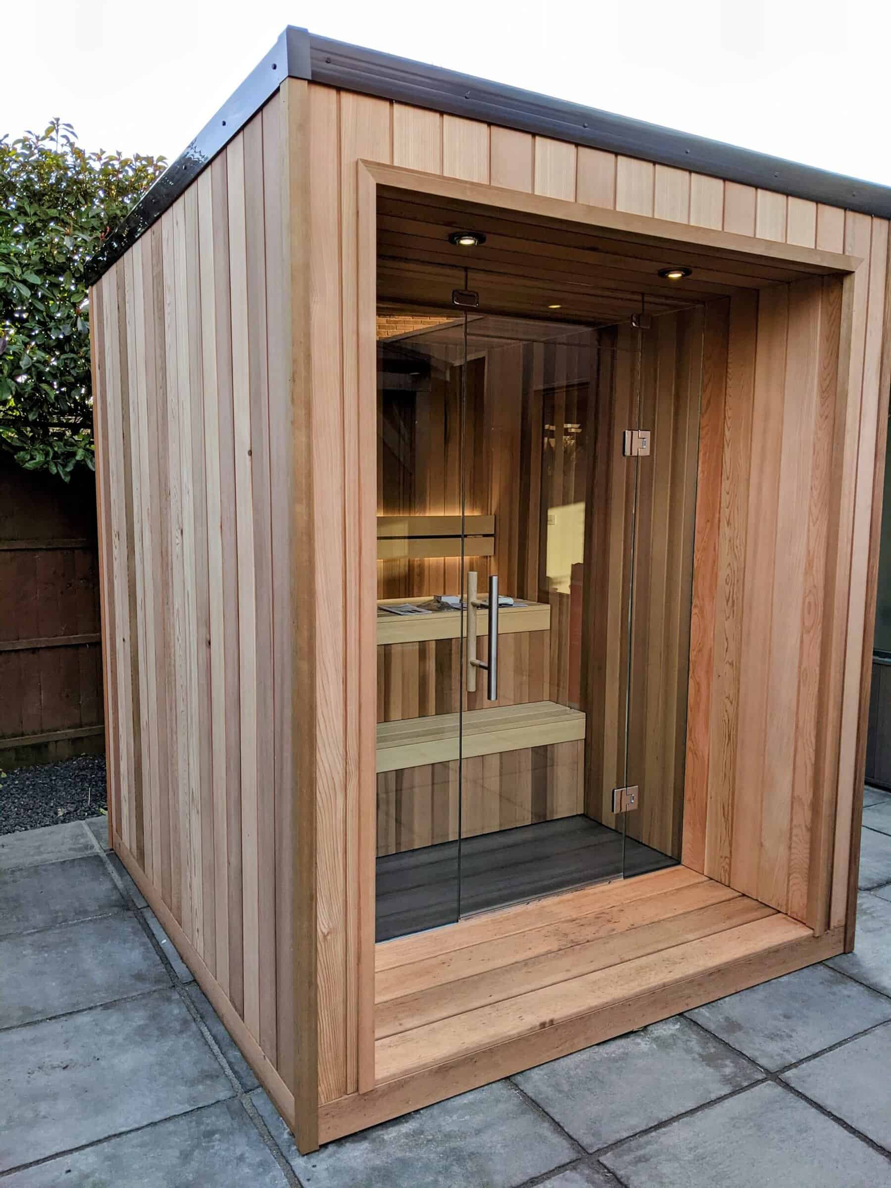 Modern outdoor wooden sauna cabin with glass door