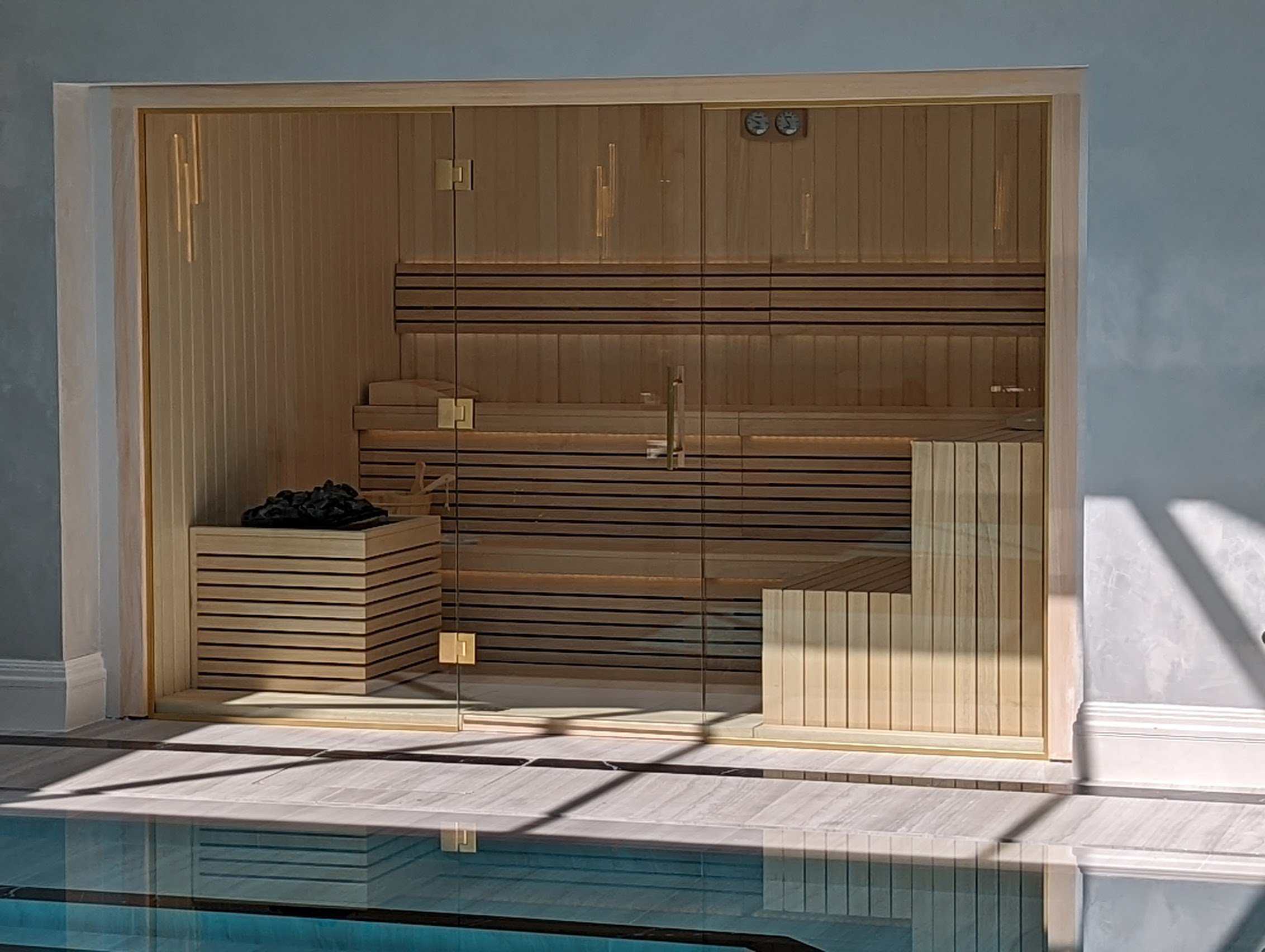 Relaxing indoor sauna with wooden interior, glass door, and seating benches