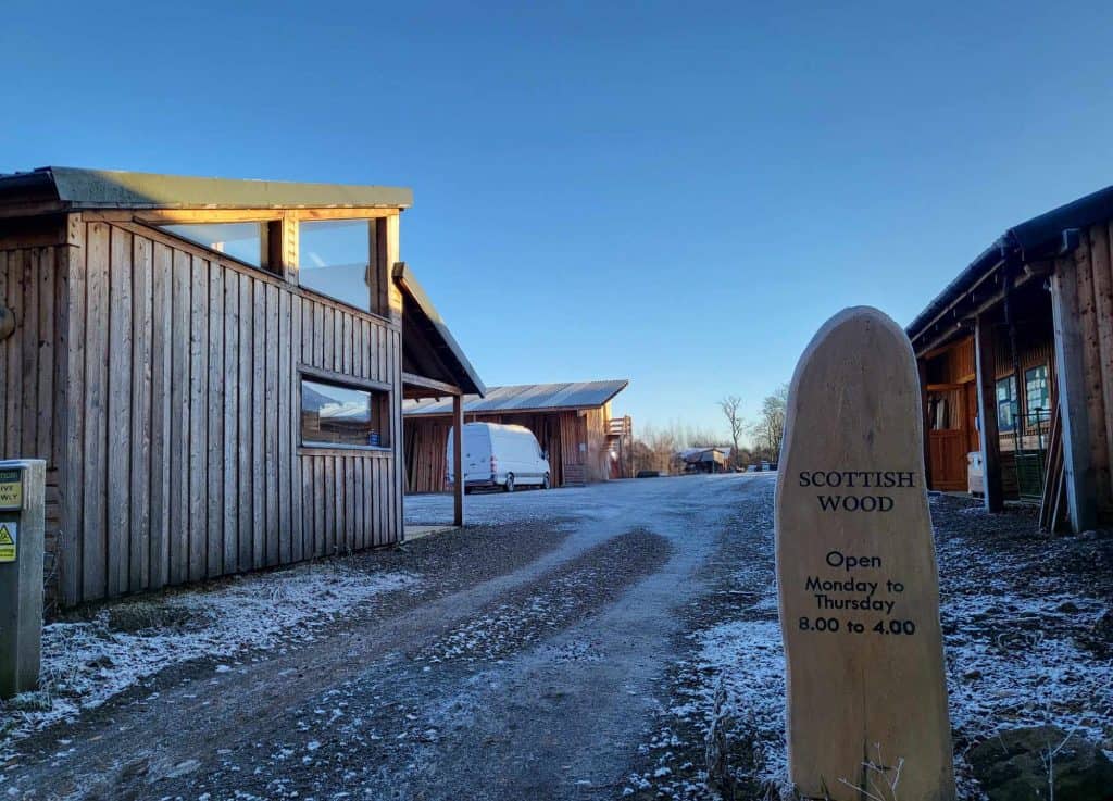 Winter photo of the entrance of the Scottish Wood yard with a bit of snow on the ground.
