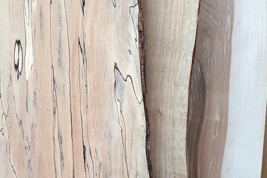 Overlapping Scottish hardwood boards featuring spalted beech, oak, ash.