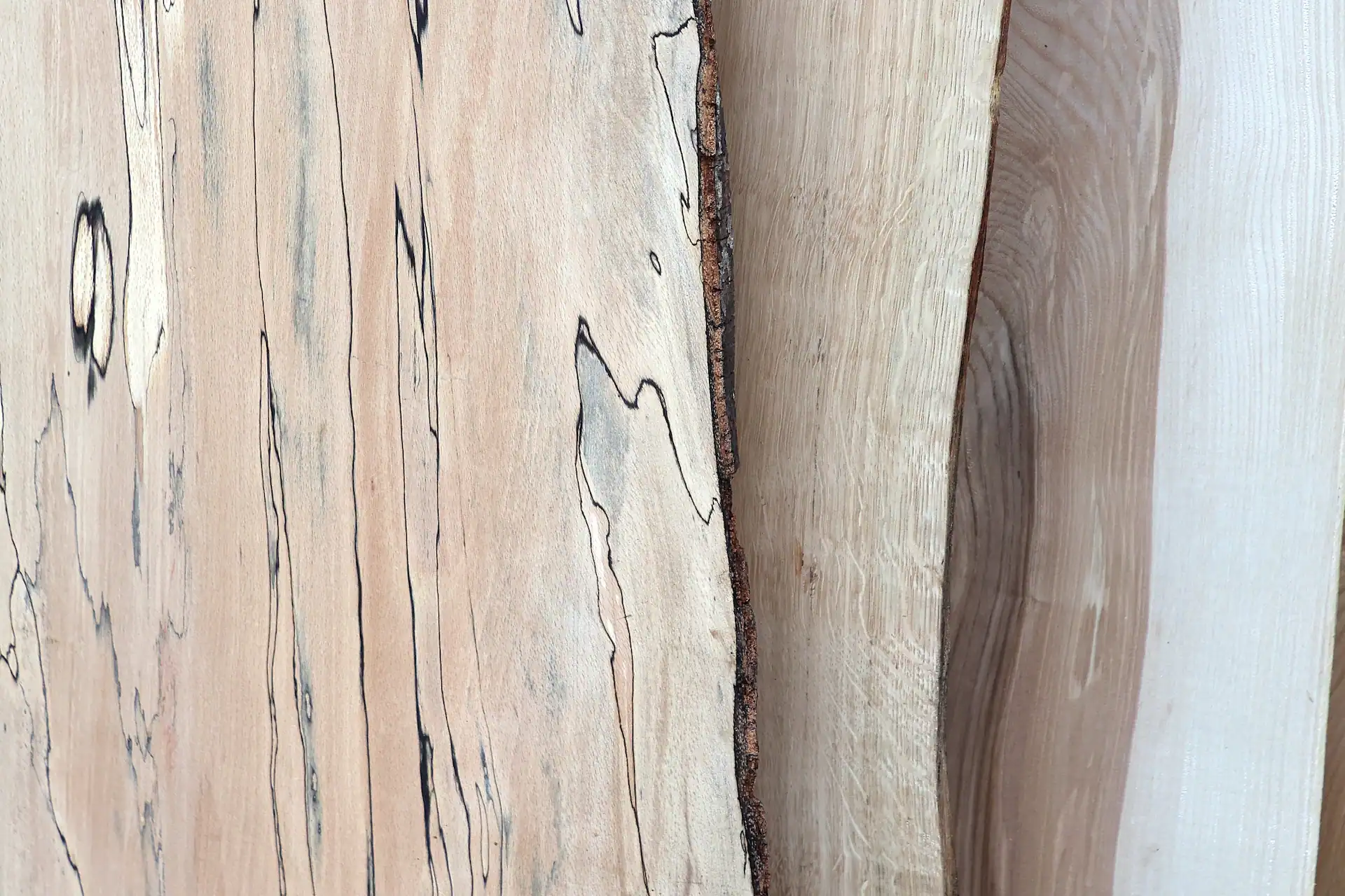 Overlapping Scottish hardwood boards featuring spalted beech, oak, ash.