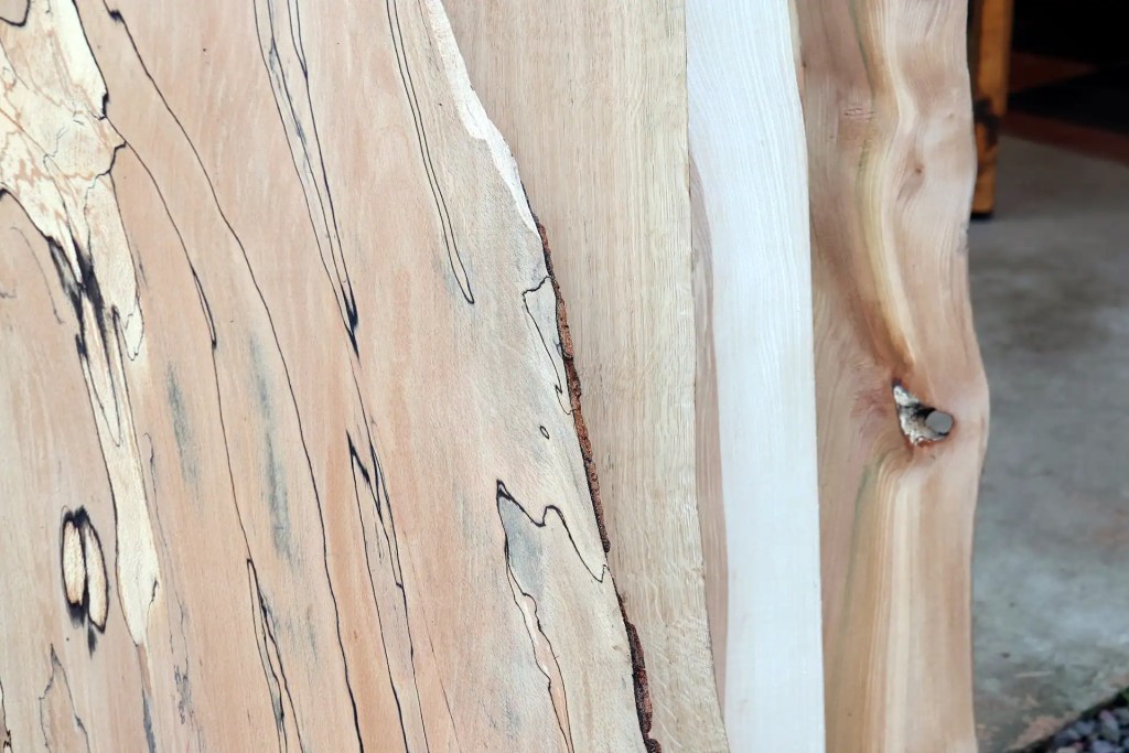 Overlapping Scottish hardwood boards featuring spalted beech, oak, ash and elm