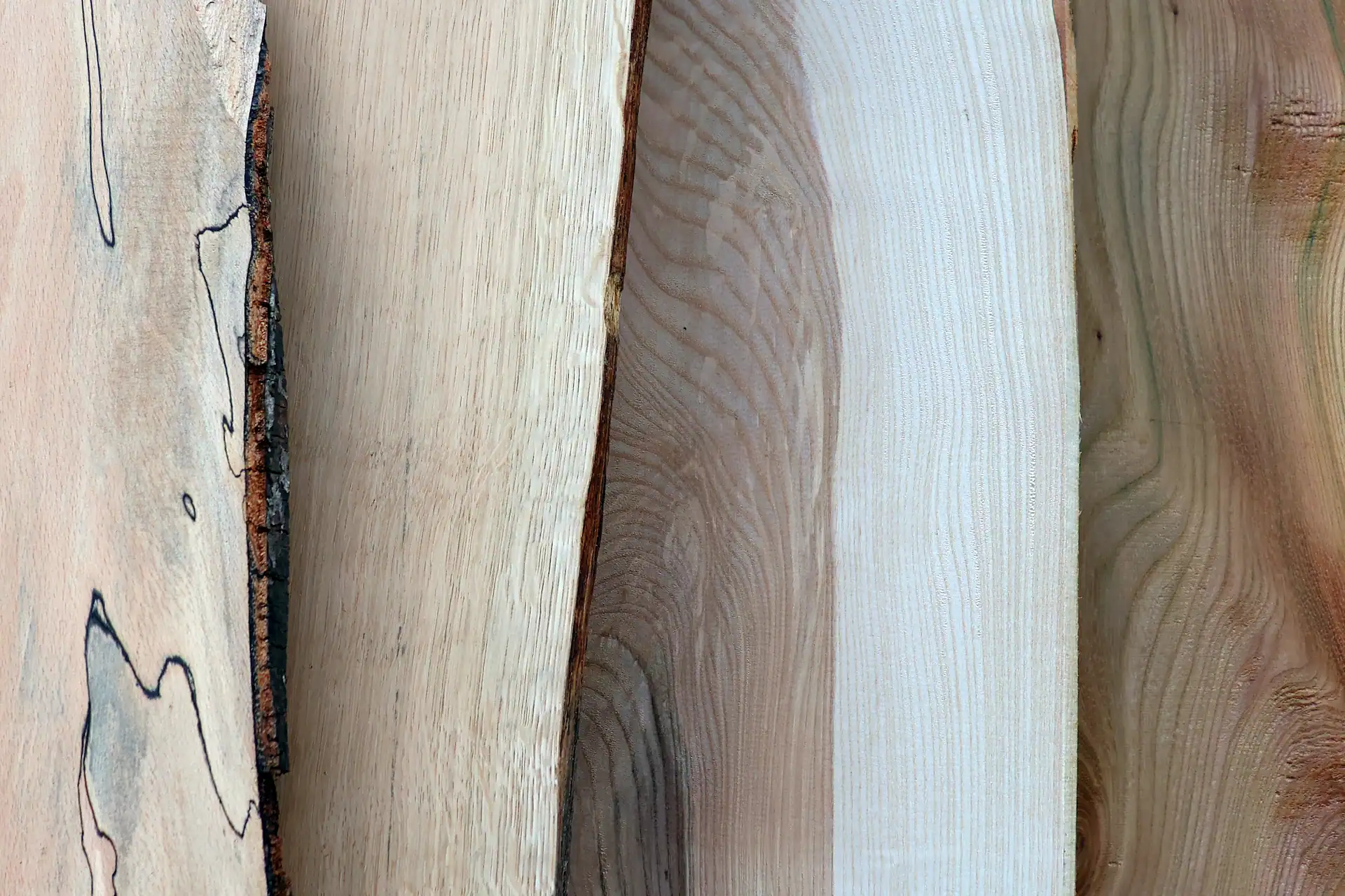 Overlapping Scottish hardwood boards featuring spalted beech, oak, ash and elm