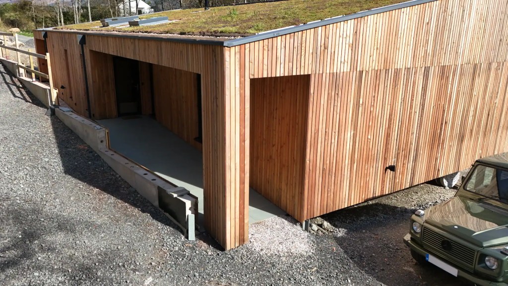 Shadow gap larch cladding used on a modern eco build with a green roof, supplied by Scottish Wood