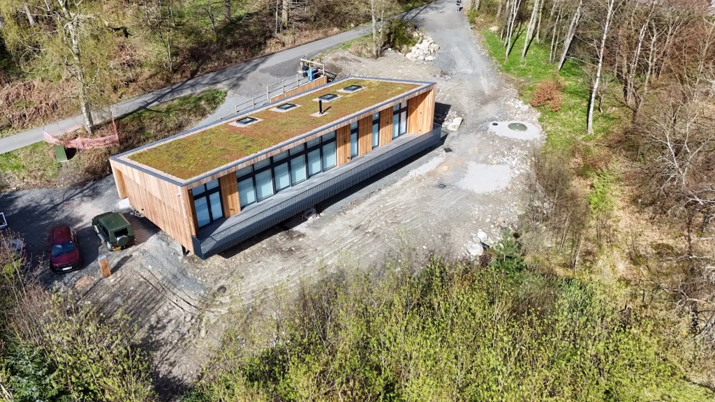 Shadow gap larch cladding used on a modern eco build with a green roof, supplied by Scottish Wood