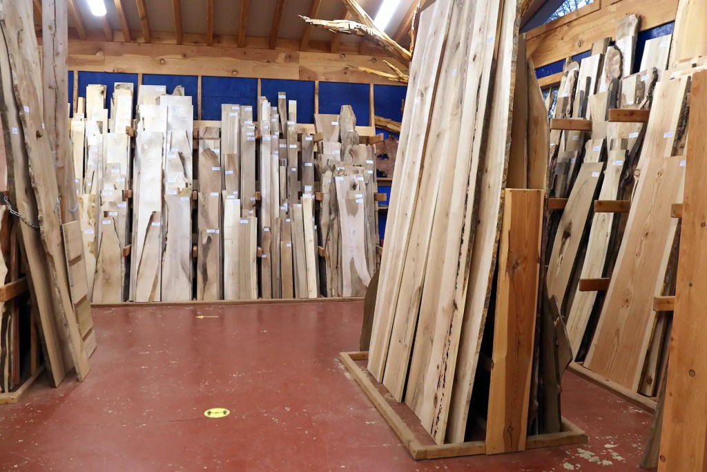 Variety of planed hardwoods in a shop, used for woodworking, joinery and furniture making