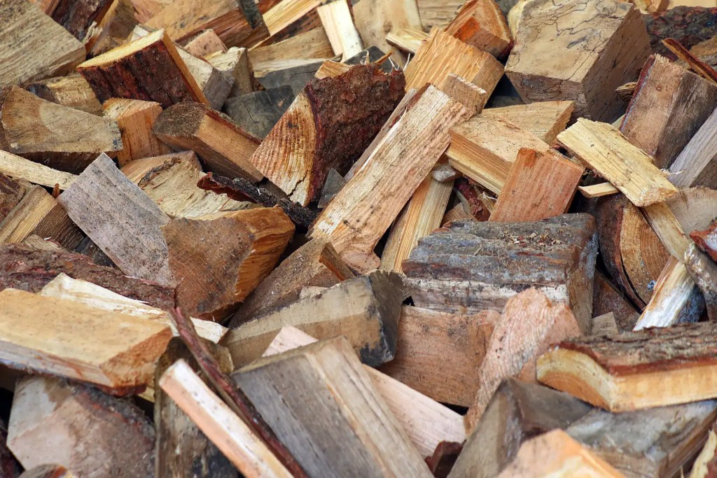 Mix of hardwood and larch firewood logs in a large pile