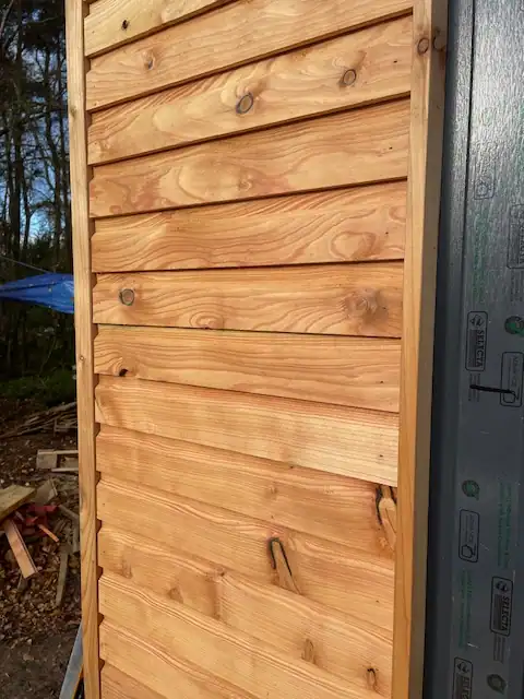 Shiplap cladding on modern hut clad in Scottish Larch