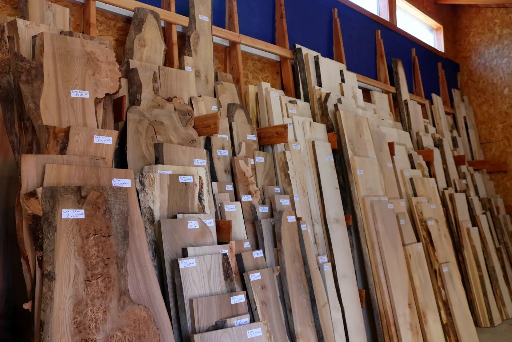 Kiln dried hardwood stock with price labels on the shelves in Scottish Wood