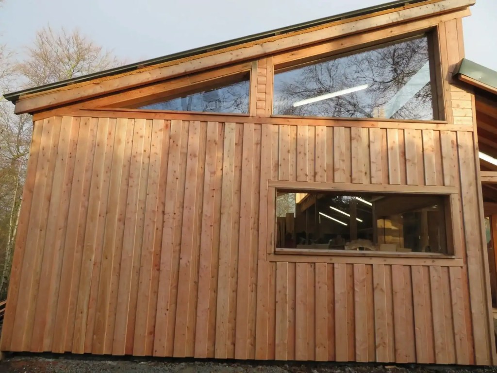 Exterior of Scottish Wood showroom building with fresh Scottish larch board on board cladding