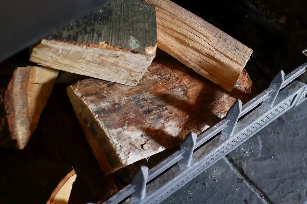Kiln dried firewood logs in fireplace