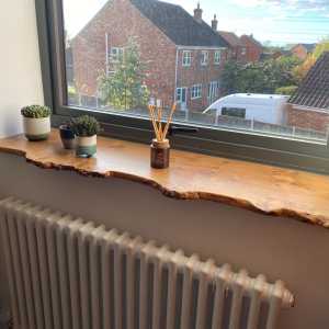 A live edge windowsill made from Scottish oak, with a natural waney edge