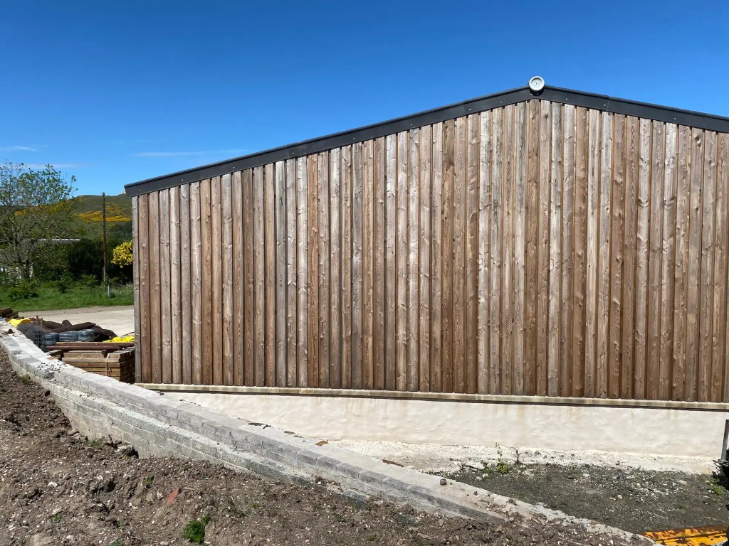 Exterior farm building with board on board Scottish Larch cladding which has weathered to silvery grey