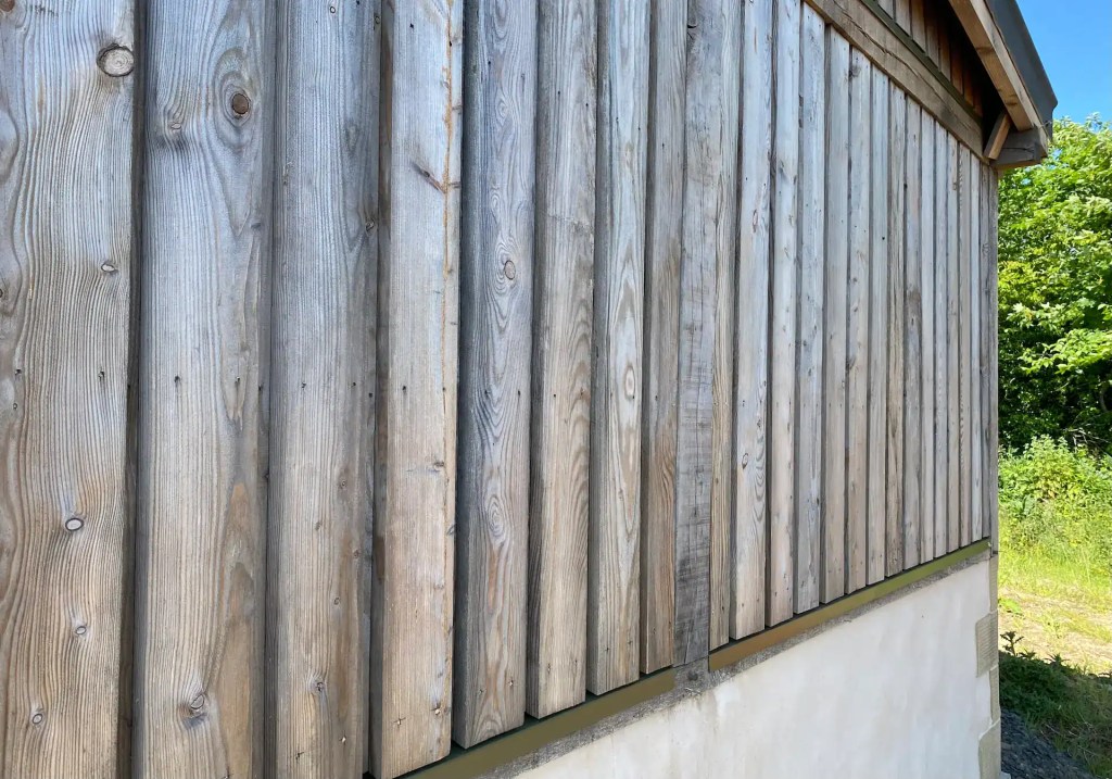 Exterior farm building with board on board Scottish Larch cladding which has weathered to silvery grey
