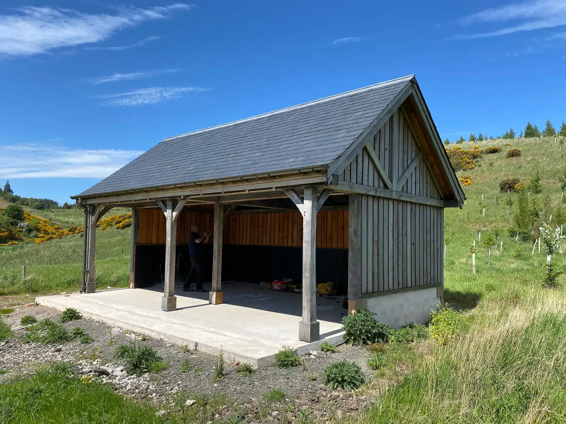 Board on board clad post and beam shed, the larch cladding has weathered to an even silver-grey