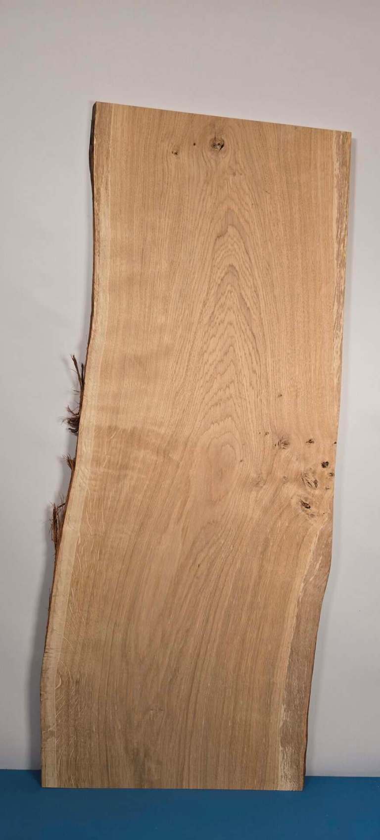 Rustic Scottish oak board with natural edge and visible wood grain.