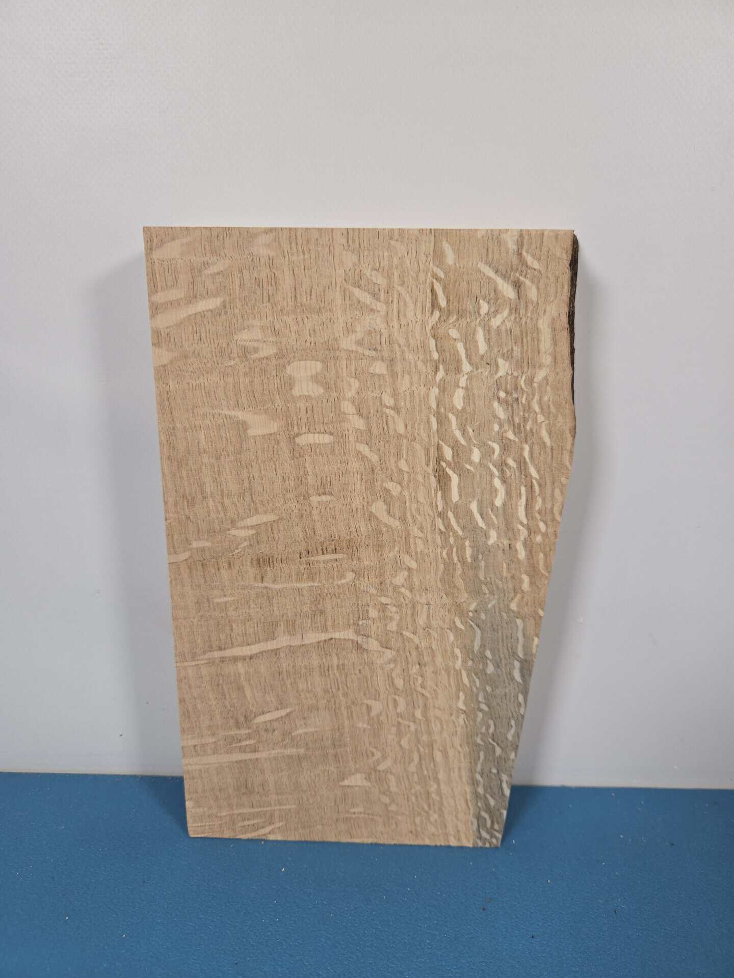 Figured oak offcut with distinctive grain pattern and textured surface.