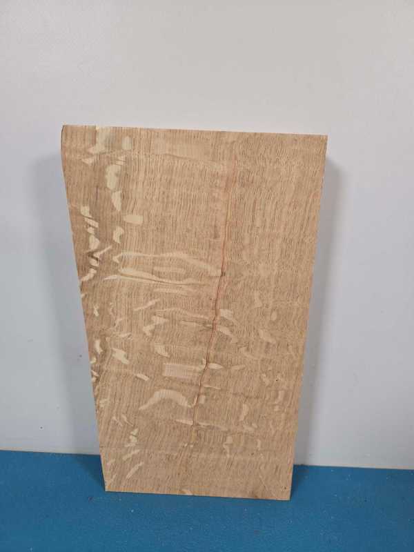 Figured oak offcut with wavy grain and natural wood finish.