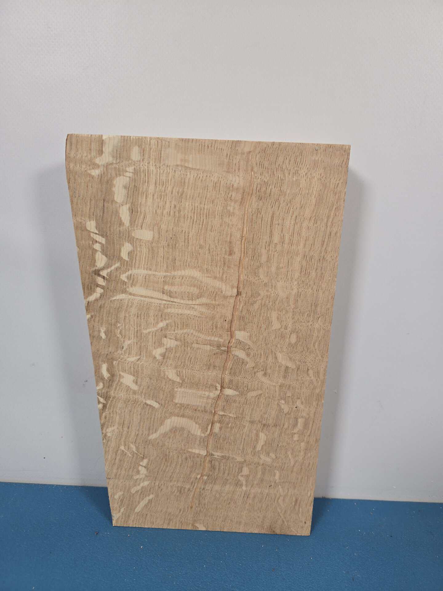 Figured oak offcut with wavy grain and natural wood finish.