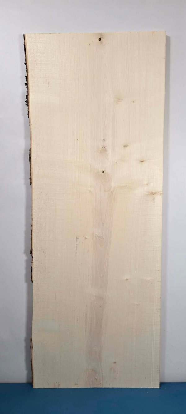 Natural edge Sycamore timber board with smooth planed surface and irregular edge.