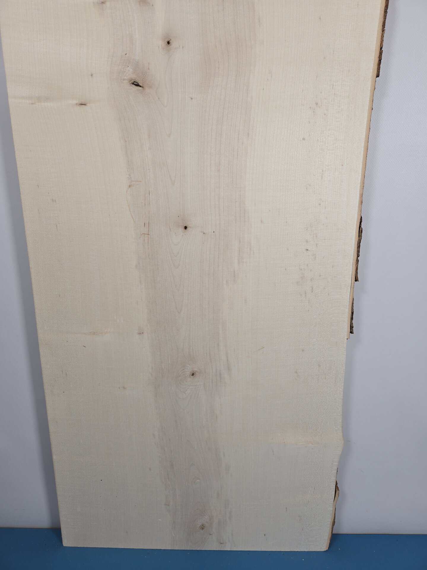 Natural edge Sycamore timber board with smooth surface and irregular edge.