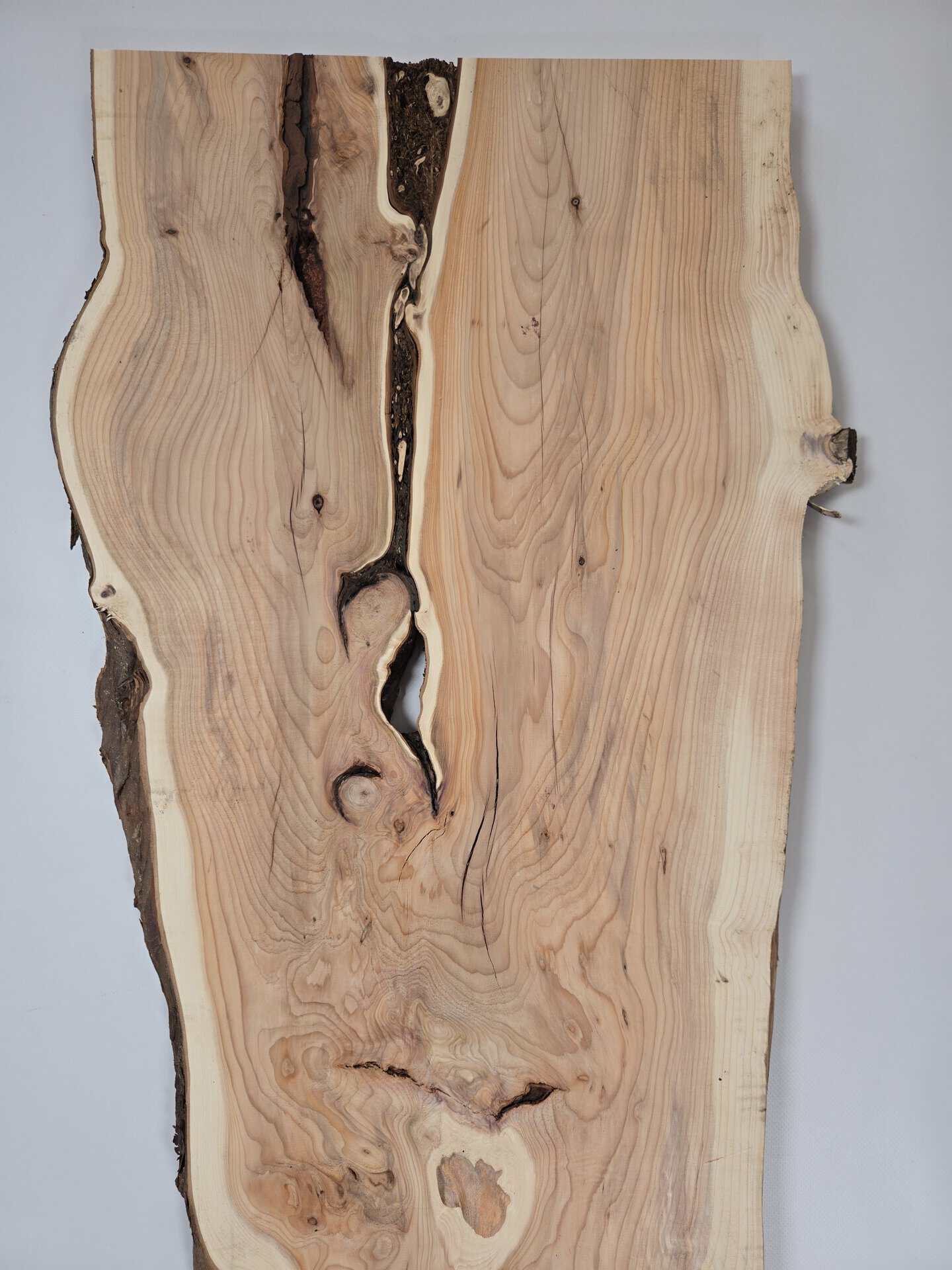 Rustic yew timber board with natural edges and unique grain patterns.