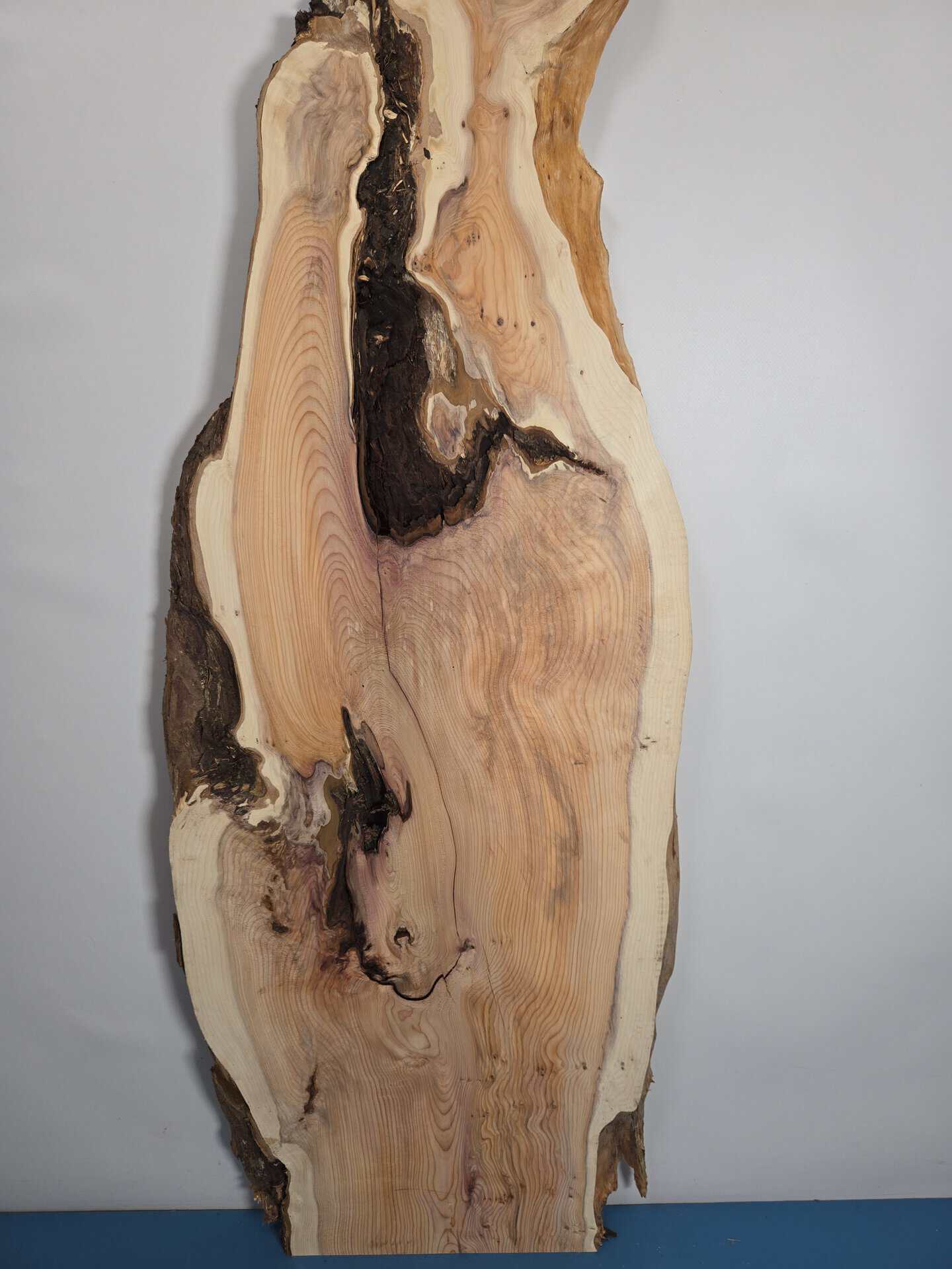 Rustic Yew wood board with natural edges and unique grain patterns.