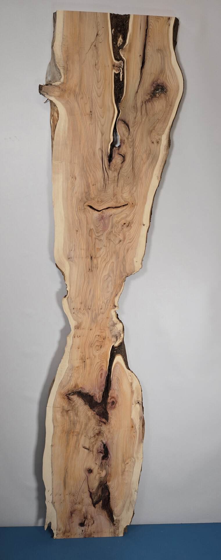 Rustic yew wood board with natural edges and unique grain pattern.
