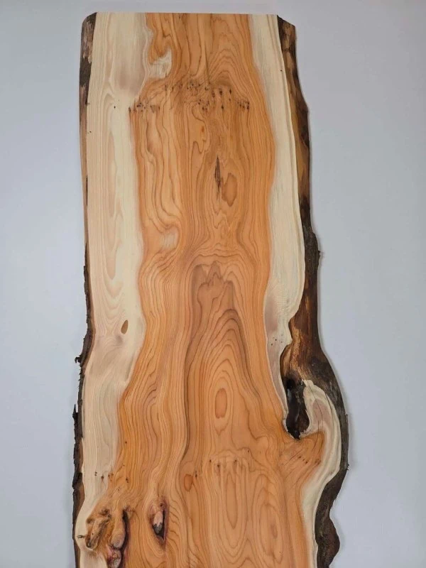Bold Yew timber board with natural edge and rich grain pattern.