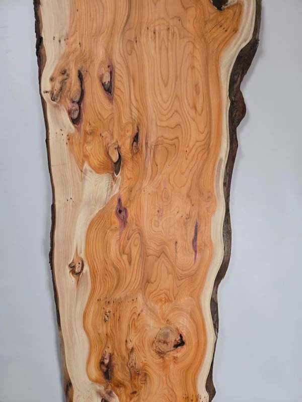 Bold Yew timber board with natural edge and rich grain pattern.