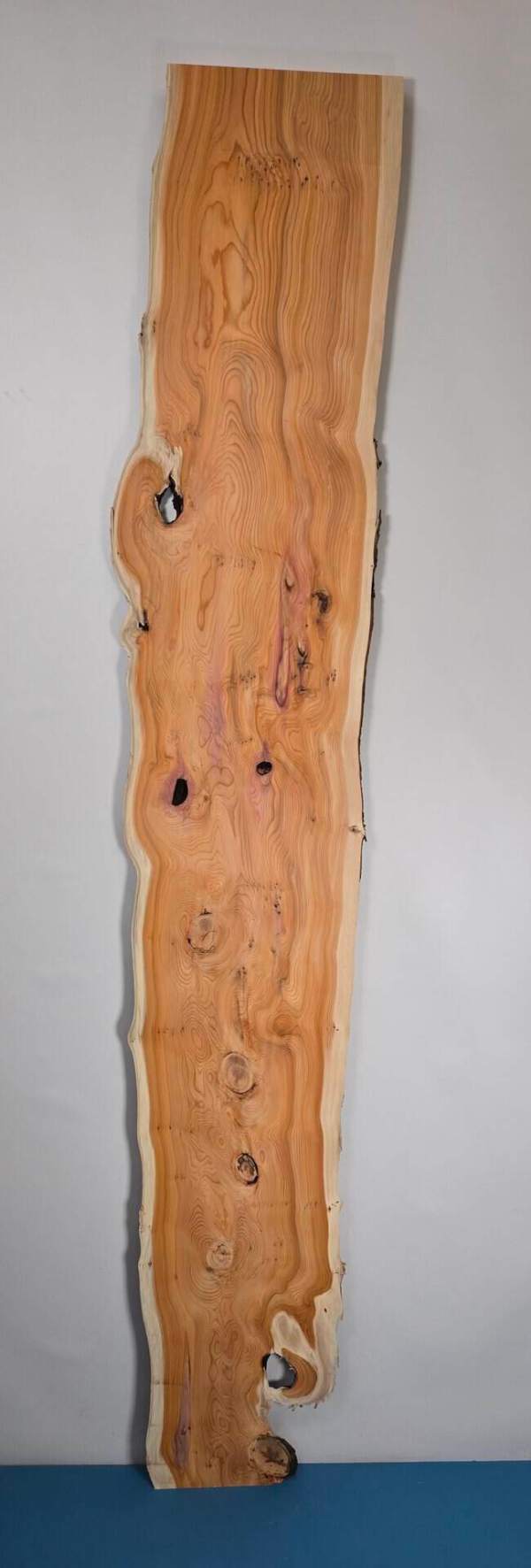 Bold yew timber board with natural edge and distinctive grain pattern.