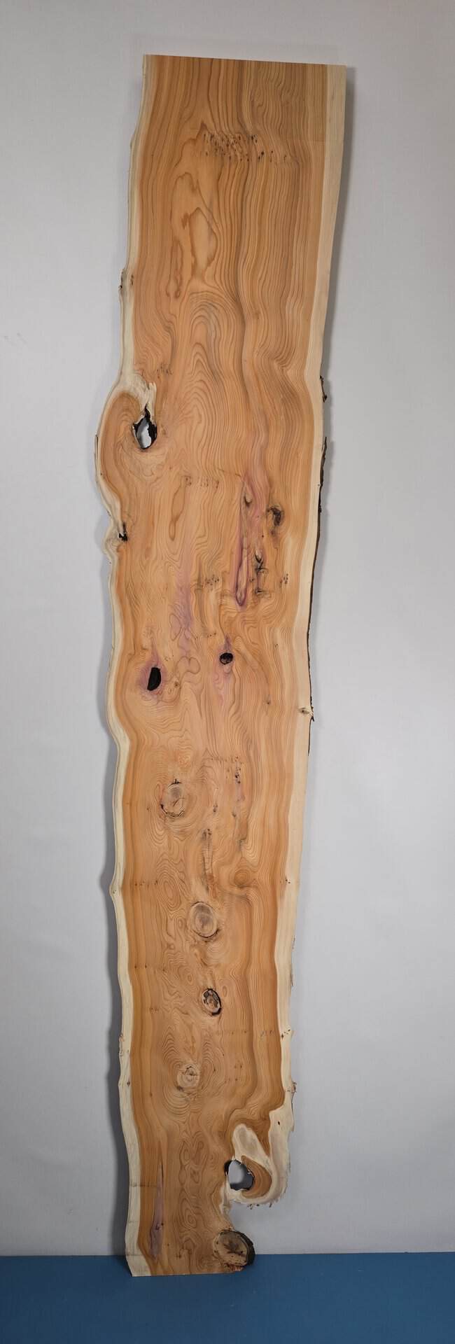 Bold yew timber board with natural edge and distinctive grain pattern.