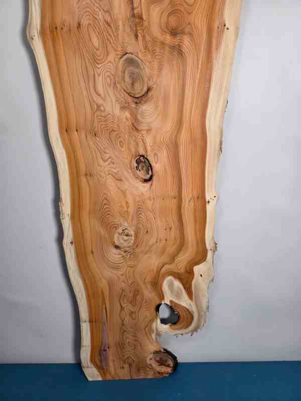 Bold Yew timber board with natural edge and distinctive grain pattern.