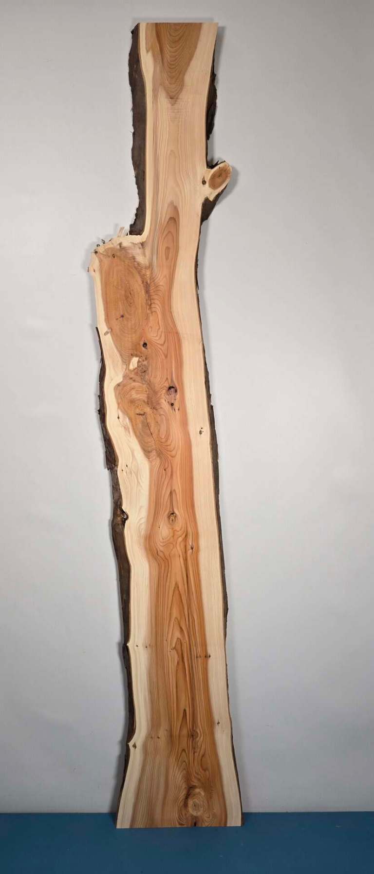 Narrow Yew timber board with natural edges and smooth planed surface.