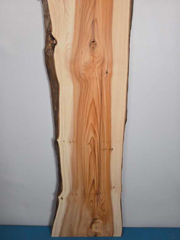 Narrow Yew timber board with natural edge and detailed grain pattern.