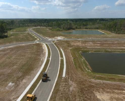 GCC Construction Site Development with new roads and water retention ponds under construction, illustrating site preparation and infrastructure improvements for future development projects.