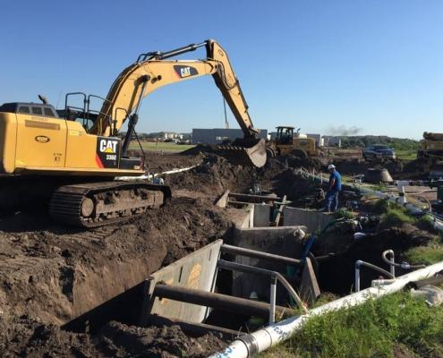 CAT excavator working on site development for infrastructure construction.