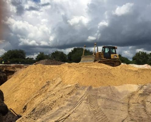 Excavation and site development with heavy machinery, preparing land for construction projects, showcasing professional site development services.