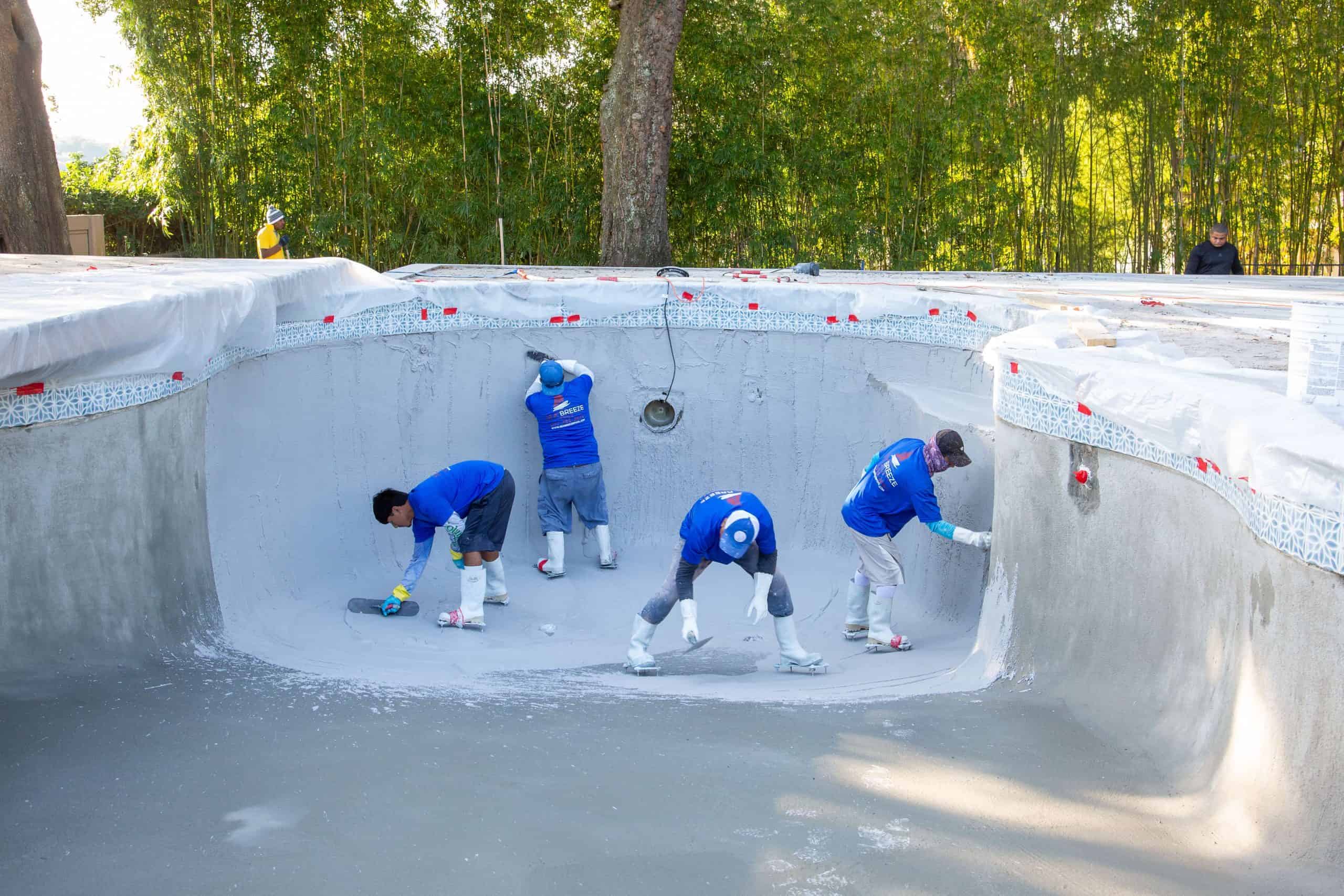 Group of pool remodelers working on upgrading a pool that adds value to Florida home.