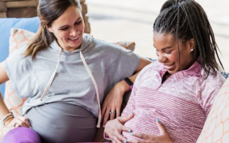 a woman touching her pregnant belly