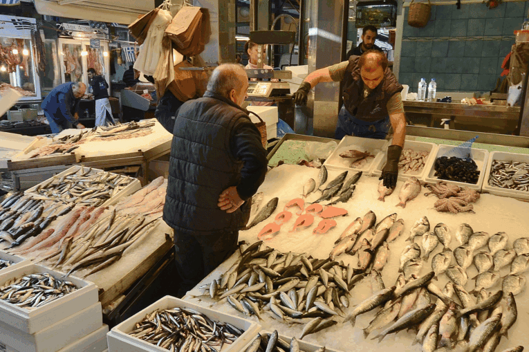 a group of men in a fish market